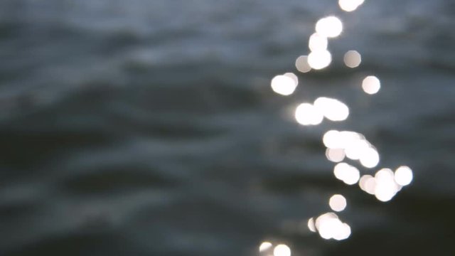 Defocused sun reflection on the sea surface, slowmotion daylight shot