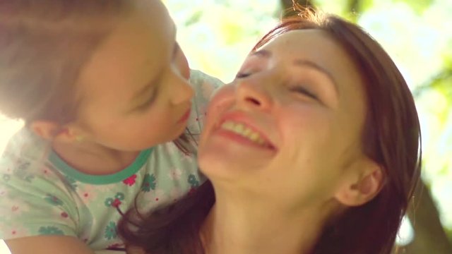 Beautiful mother and her little daughter in summer park. Slow motion 240 fps. Full HD video 1920X1080