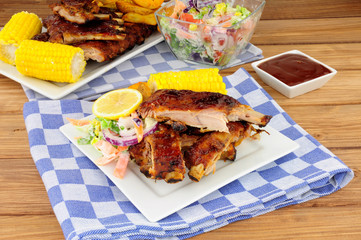 Barbecued pork ribs meal with sweetcorn and fresh salad