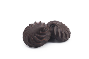 two chocolate covered marshmallows, part of one bitten off, isolated on white background