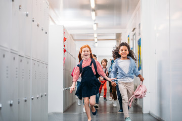pupils running through school corridor