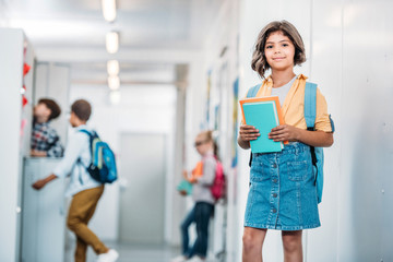 schoolgirl with books in corridor