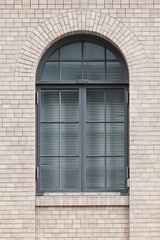 Fototapeta na wymiar Metal window frame and white brick wall building