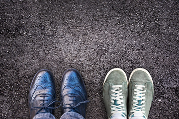Sneakers and business shoes side by side on asphalt, work life balance concept