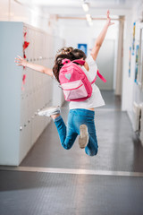 girl jumping in school corridor © LIGHTFIELD STUDIOS