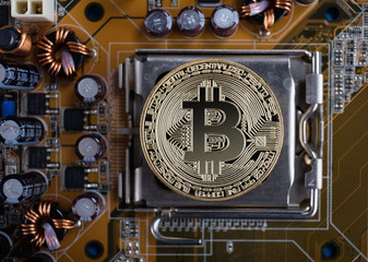 Gold bitcoin with microcircuits on a blue background. The concept of cryptocurrency..