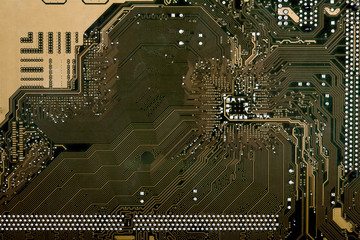 Gold bitcoin with microcircuits on a green background. The concept of cryptocurrency..