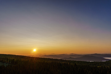 Fototapeta na wymiar Spectacular dawn over mountain range in Sheregesh, Siberia 