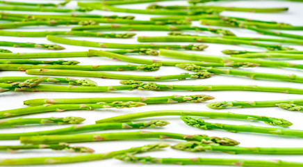 Fresh green asparagus shoots pattern, top view. Isolated over white. Food background asparagus flat lay pattern