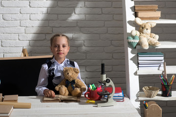 Back to school and childhood concept. Schoolgirl with proud face