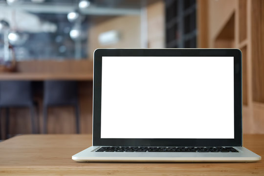 Mock up Blank screen of Laptop on marble table in Co-working or cafe.