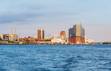 Fototapeta premium river Elbe with harbor, Sankt Pauli piers and Elbphilharmonie concert hall in Hamburg, Germany under clear blue sky