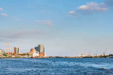 river Elbe with harbor, Sankt Pauli piers and Elbphilharmonie concert hall in Hamburg, Germany under clear blue sky