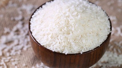 Close up of white rice in the wooden bowl. 