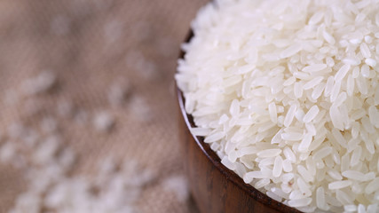 Close up of white rice in the wooden bowl. 