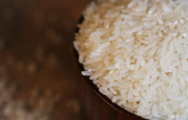 Close up of white rice in the wooden bowl. 