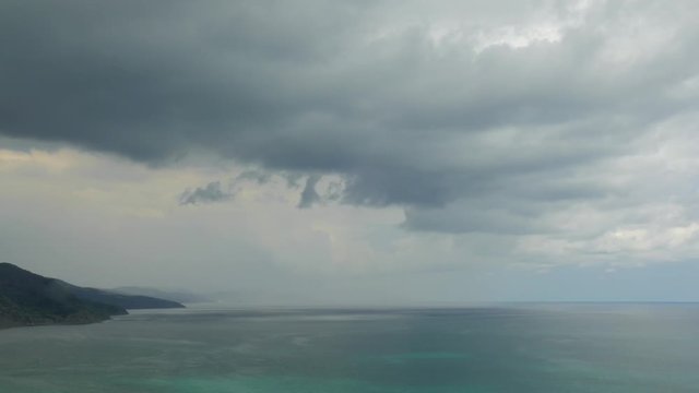 Seascape on cloudy day, time lapse / Mountains on sea coast on rainy misty day, time lapse