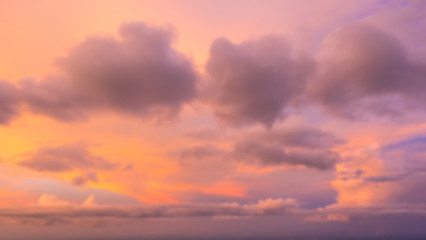 Dramatic sunset sky with clouds. Blur or defocus image.