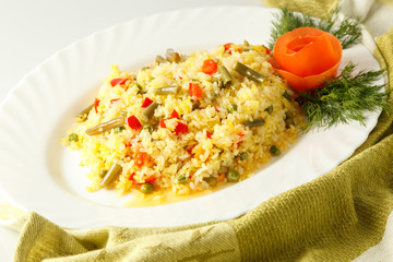 pilaf with meat on a white plate