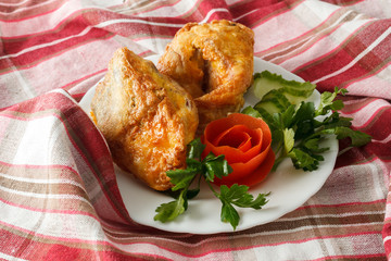 fish in batter with greens on a white plate