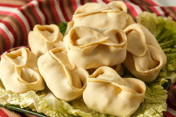 Frozen dumplings on the white plate with green