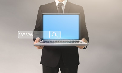  business man and suit holding laptop in hands