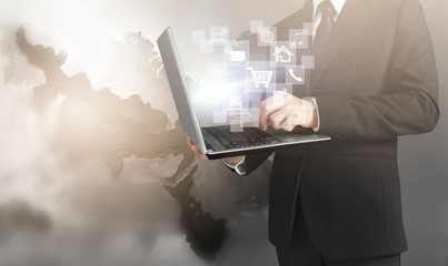  business man and suit holding laptop in hands