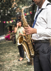 Obraz na płótnie Canvas a man plays the saxophone