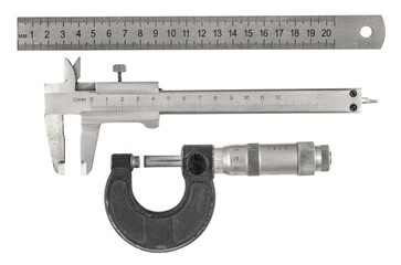 Three old measurement tools - ruler, calipers and  micrometer on white background