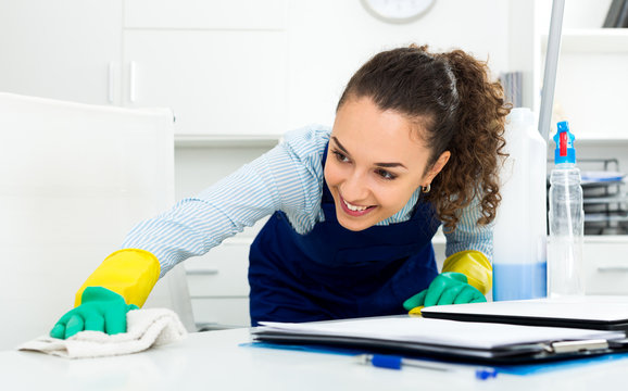 Woman with supplies cleaning in office