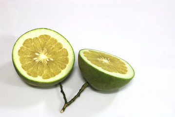 The two sliced pomelo are on white background.They are a kind of grapefruit and a dilicious thai fruit. 
