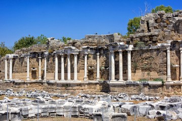 Fountain of Nymphaeus in Side, Turkey. Beautiful ruins of a great structure against the blue sky.