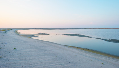 Artificial island under construction in a lake at sunset in summer