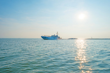 Boat sailing on a lake at sunset in summer