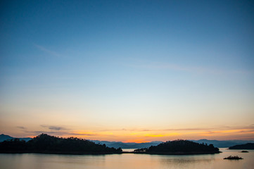 Fototapeta premium Landscape view of tranquil mountain and lake at sunset