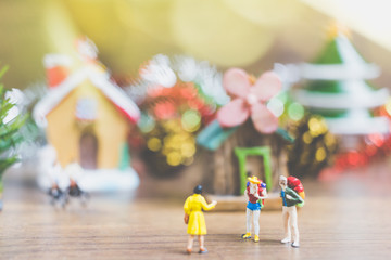 Miniature people in the village celebrate Christmas Day , Holiday concept.