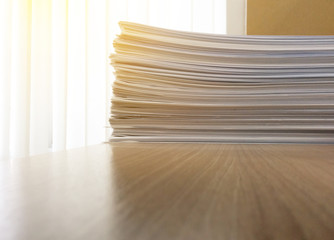 Business file documents paper stack on office wood table