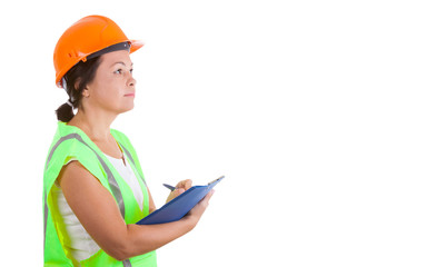 Attractive Woman Worker in Safety Jacket and Yellow Helmet Holding Clipboard