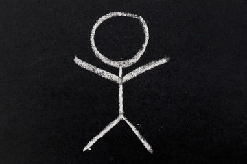 White chalk drawing as human shape on black board background