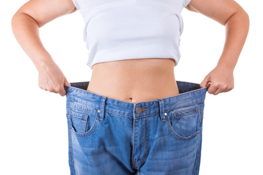 Diet Concept. Slim Women in Big Jeans Showing Successful Weight Loss