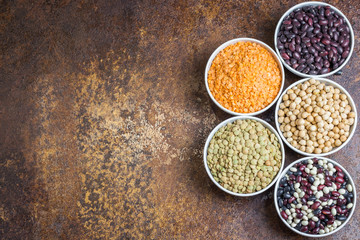 Various legumes on stone background. Top view, space for text.