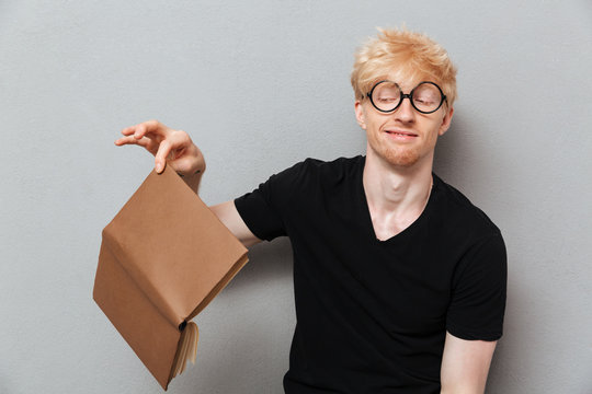 Disapointed Caucasian Man Holding Book.