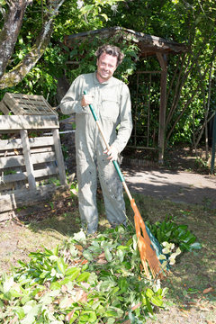 a forties man outdoors house home gardening with raking