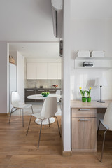 Interior of modern apartment in scandinavian style with kitchen and workplace.