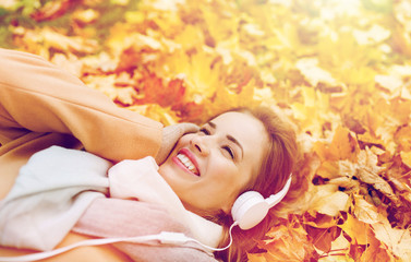 woman with headphones listening to music in autumn