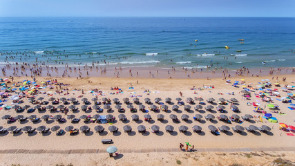 Aerial. Photos of beach and tourists of city of Albufeira. From sky.