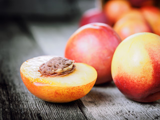 Fresh ripe nectarine peach fruit, crop rustic background