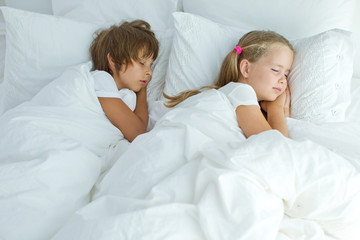 Children sleep in bed 