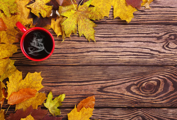 Autumn leaves and cup of coffee