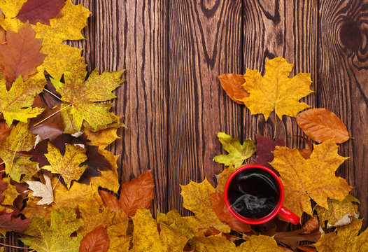 Autumn leaves and cup of coffee
